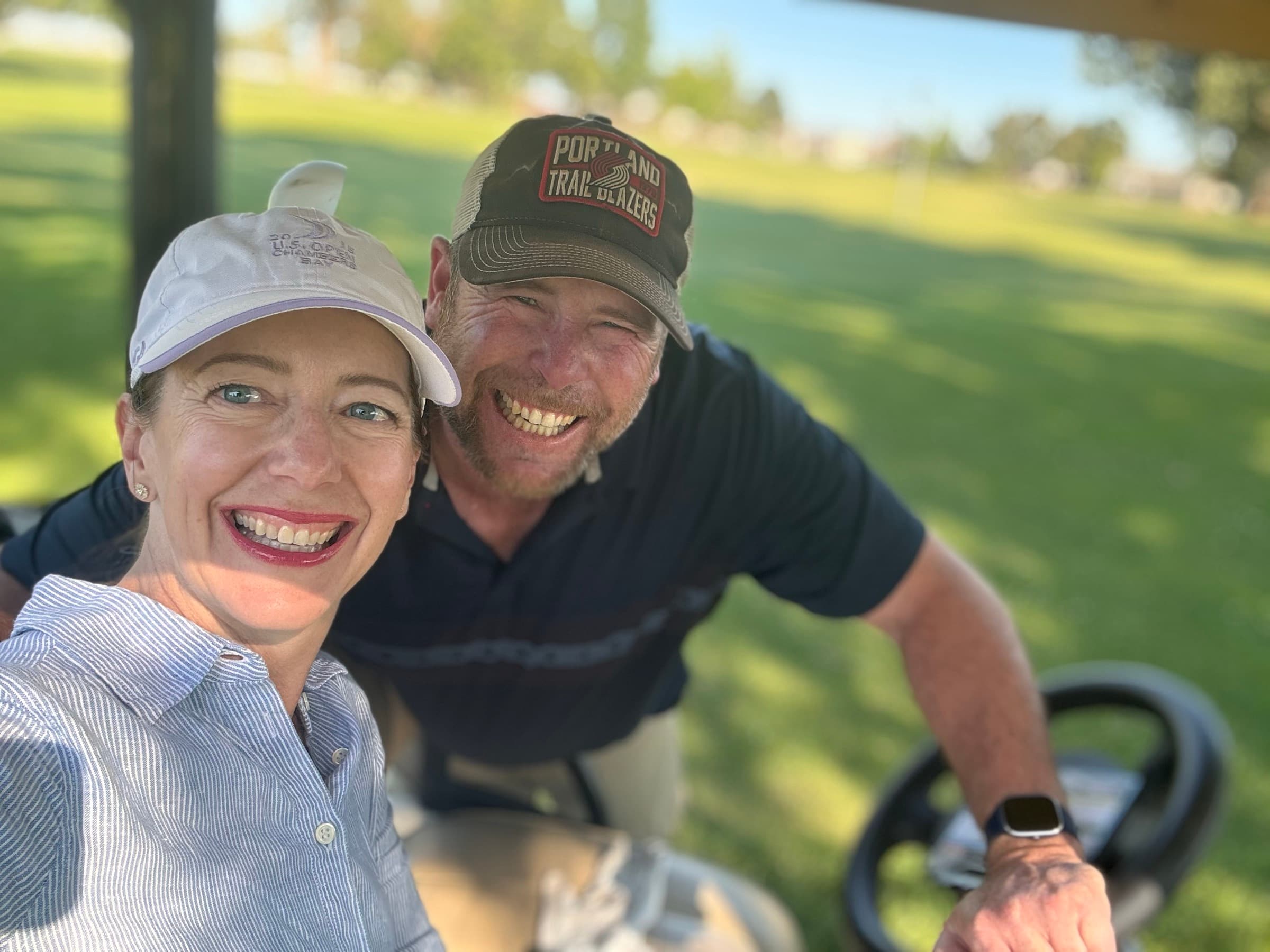 TJ and his wife on the golf course