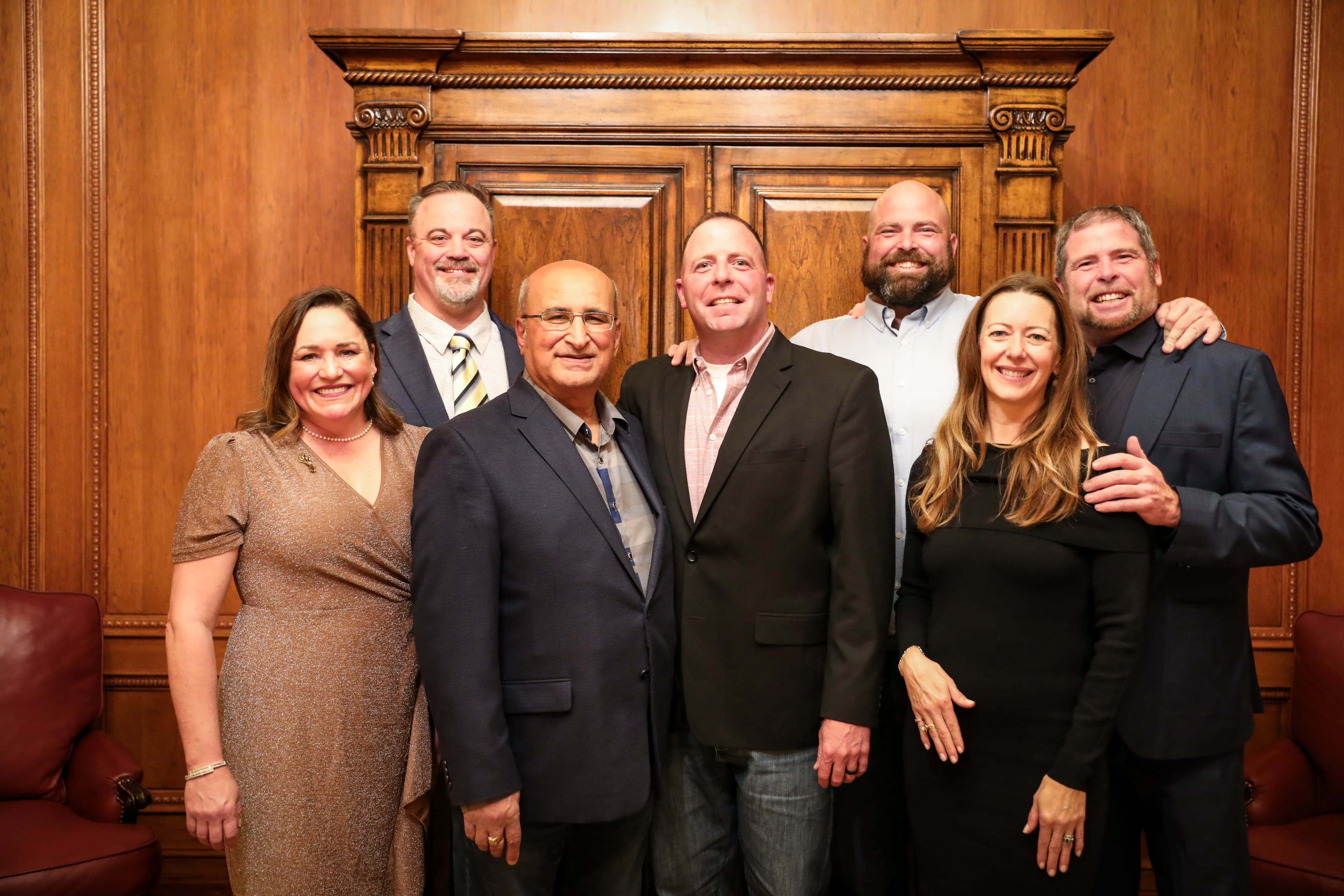 TJ Hansell with colleagues at a formal gathering